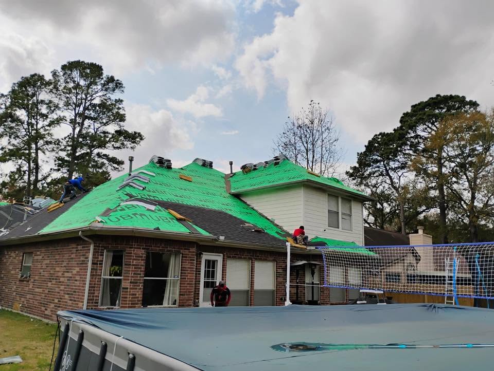 Carlos Affordable Roofing crew installing a new roof